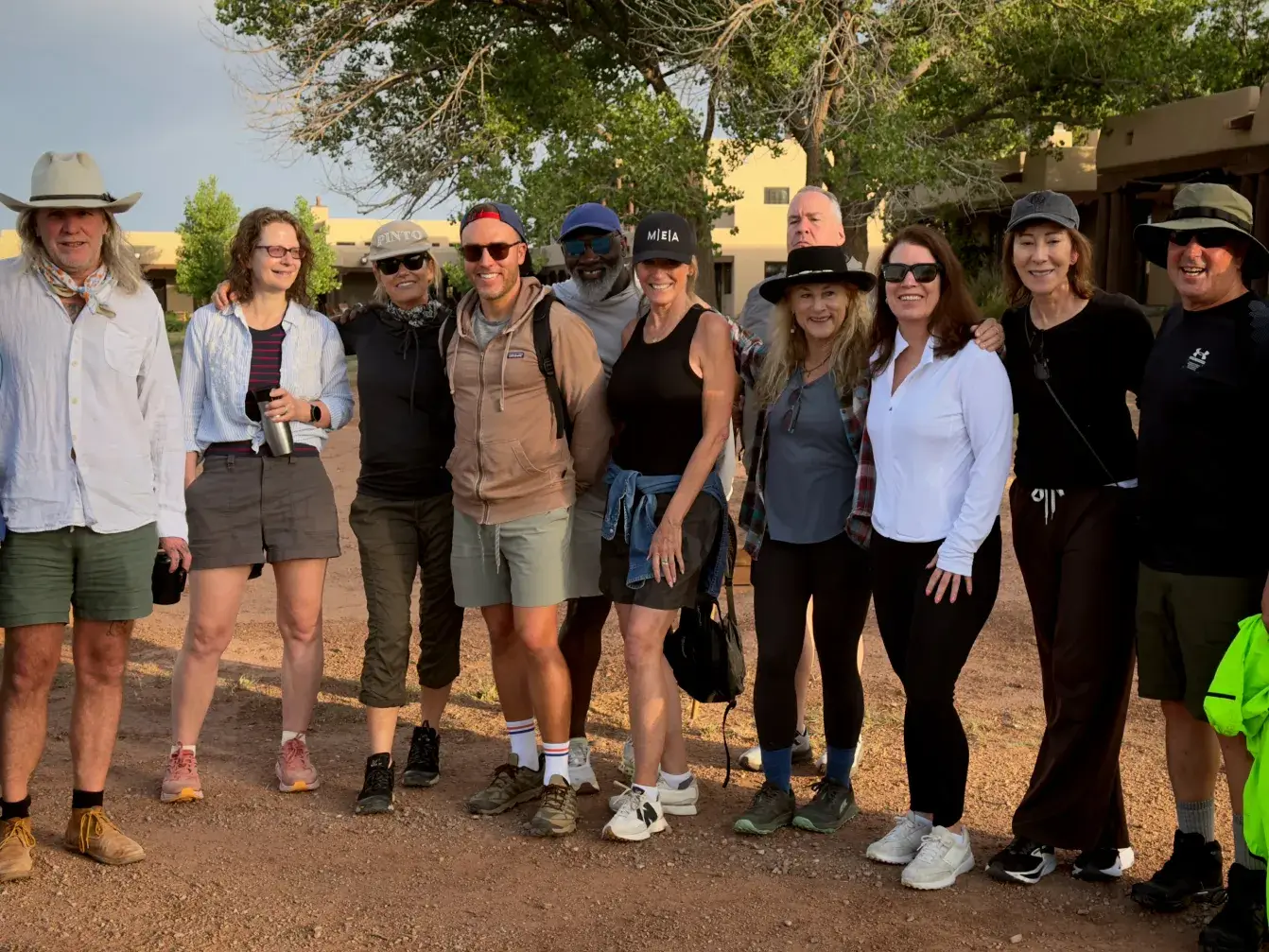 A diverse group of participants gather outdoors, showcasing camaraderie at a Leadership Retreat Venue event.